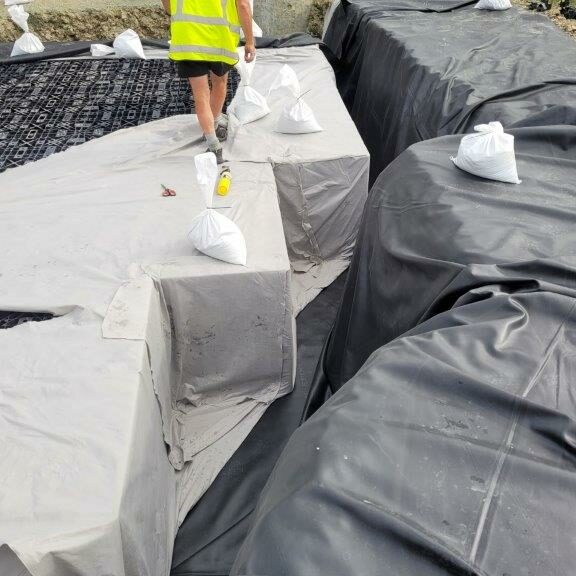 Impermeable liner installed around storm water detention tank